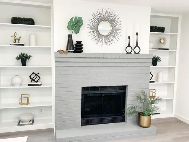 a front view of a fireplace with cabinets