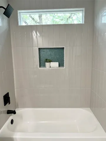 a bathroom with a bathtub and a shower