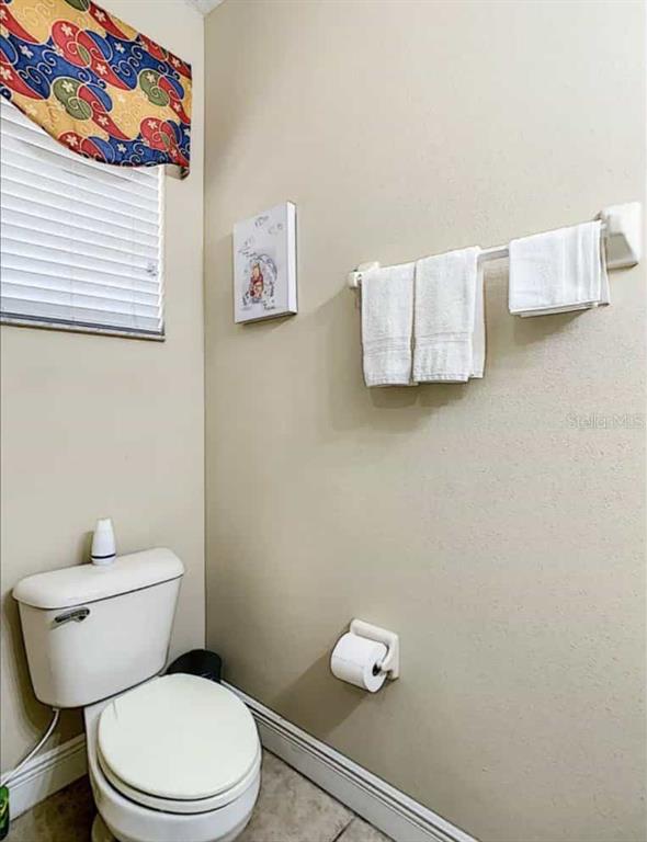 889 Assembly Court Reunion, FL 34747 - Photo 17 of 19 a white toilet sitting next to a bathroom sink