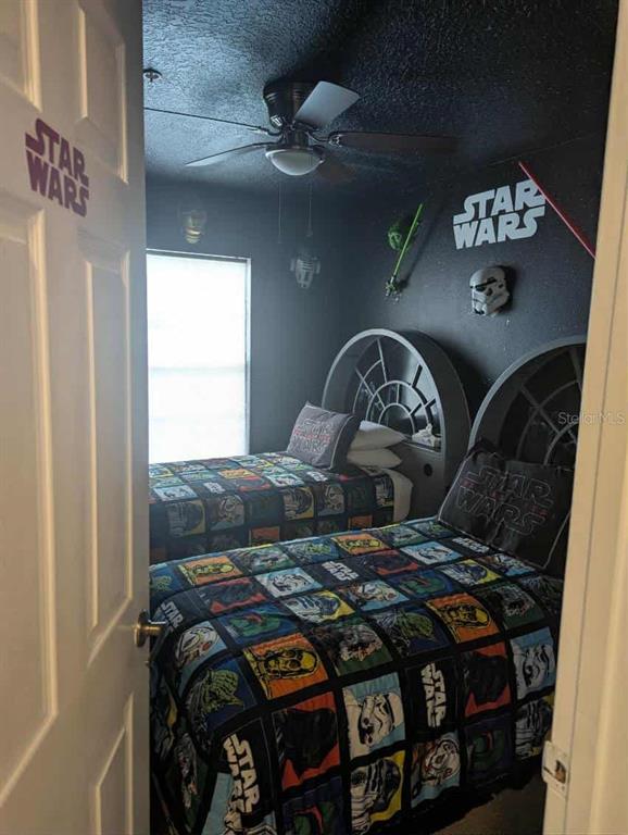 889 Assembly Court Reunion, FL 34747 - Photo 18 of 19 a bed sitting in a bedroom next to a window