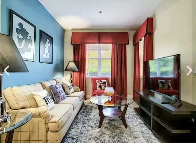 a living room with furniture fireplace and flat screen tv