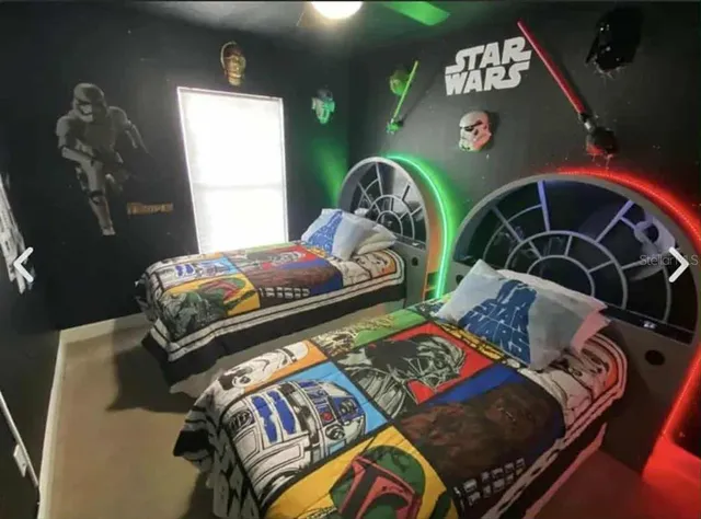 a bedroom with two beds and a window