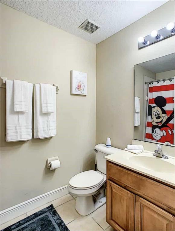 889 Assembly Court Reunion, FL 34747 - Photo 10 of 19 a bathroom with a toilet a sink and mirror