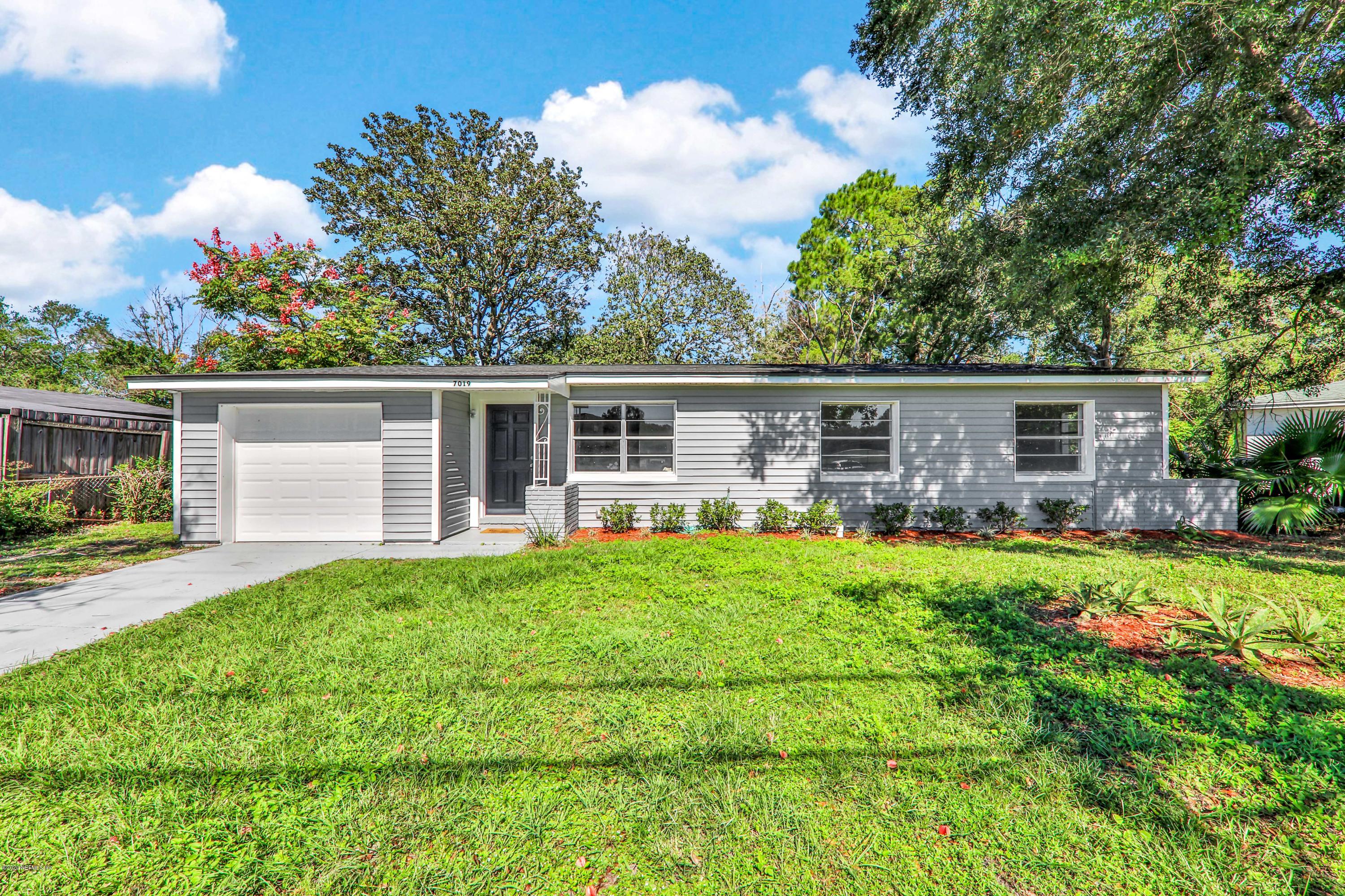 7019 Melvin Road Jacksonville, FL 32210 - Photo 1 of 22 front view of a house with a big yard