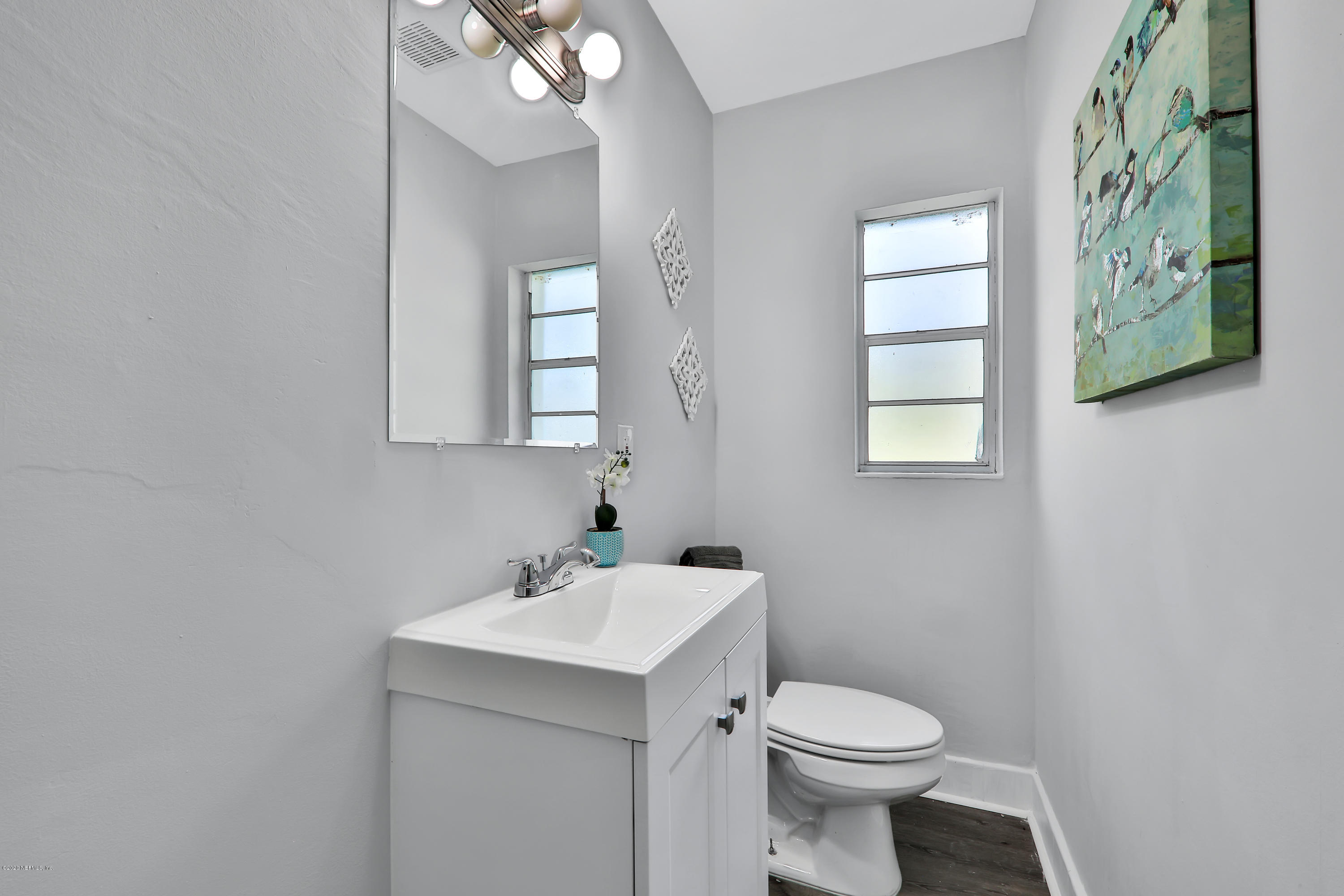 7019 Melvin Road Jacksonville, FL 32210 - Photo 11 of 22 a bathroom with a sink toilet and a mirror