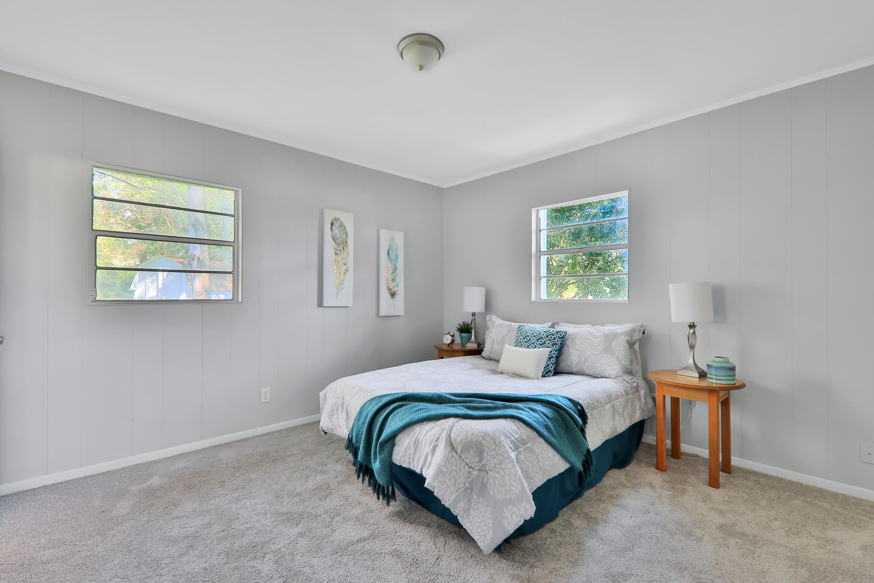 7019 Melvin Road Jacksonville, FL 32210 - Photo 12 of 22 a bedroom with a bed and a window