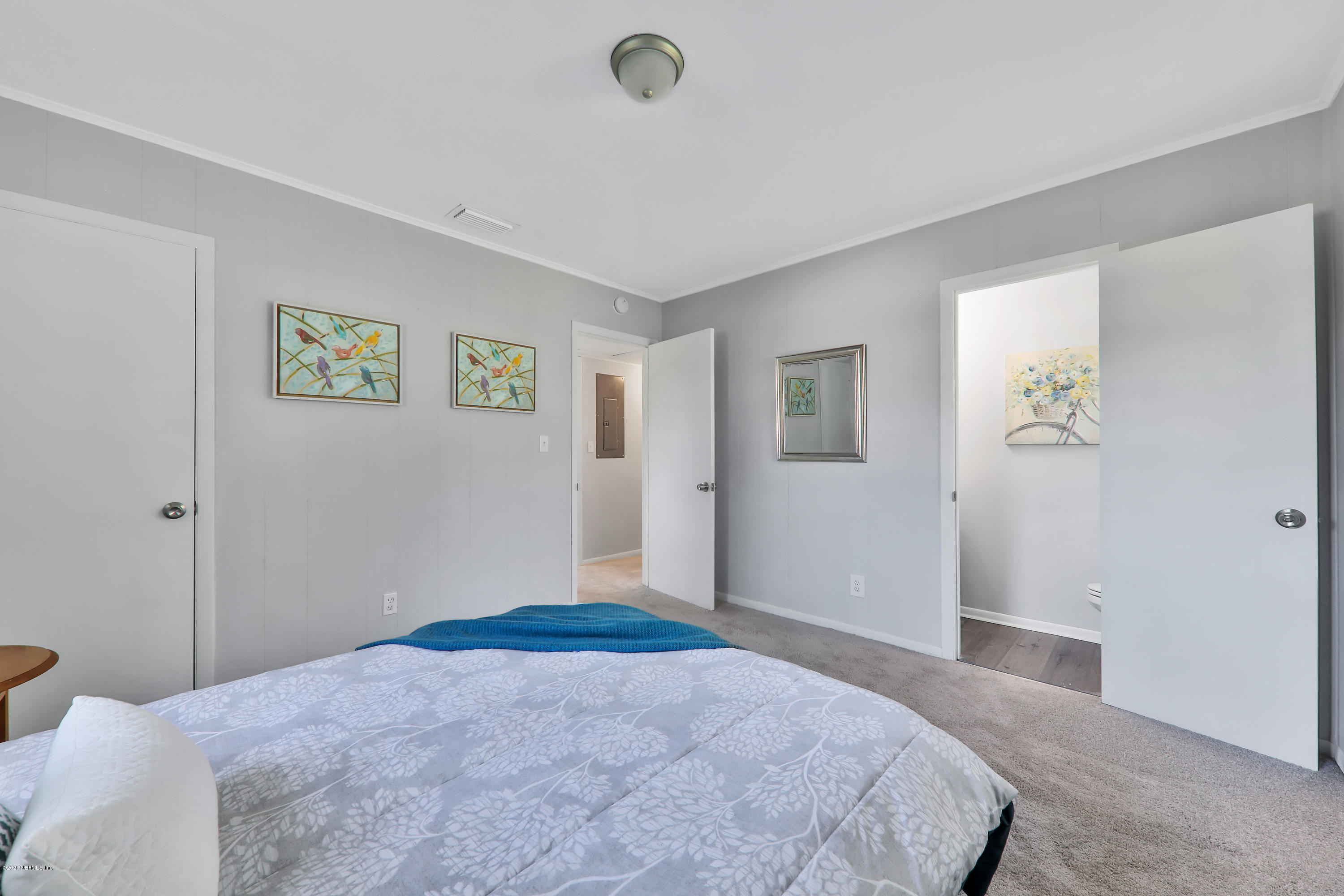7019 Melvin Road Jacksonville, FL 32210 - Photo 13 of 22 a bedroom with a bed and a window