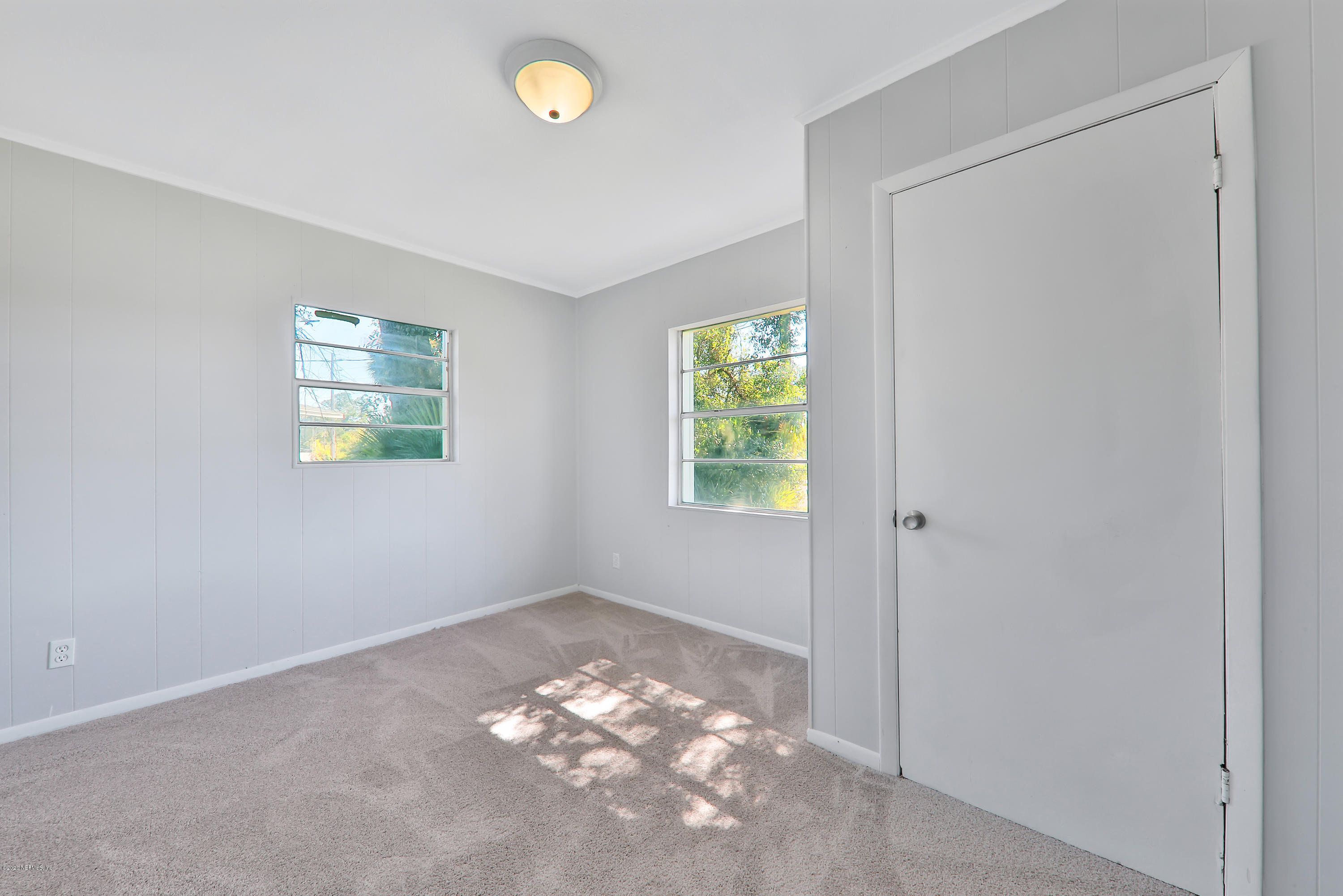 7019 Melvin Road Jacksonville, FL 32210 - Photo 15 of 22 an empty room with windows and closet