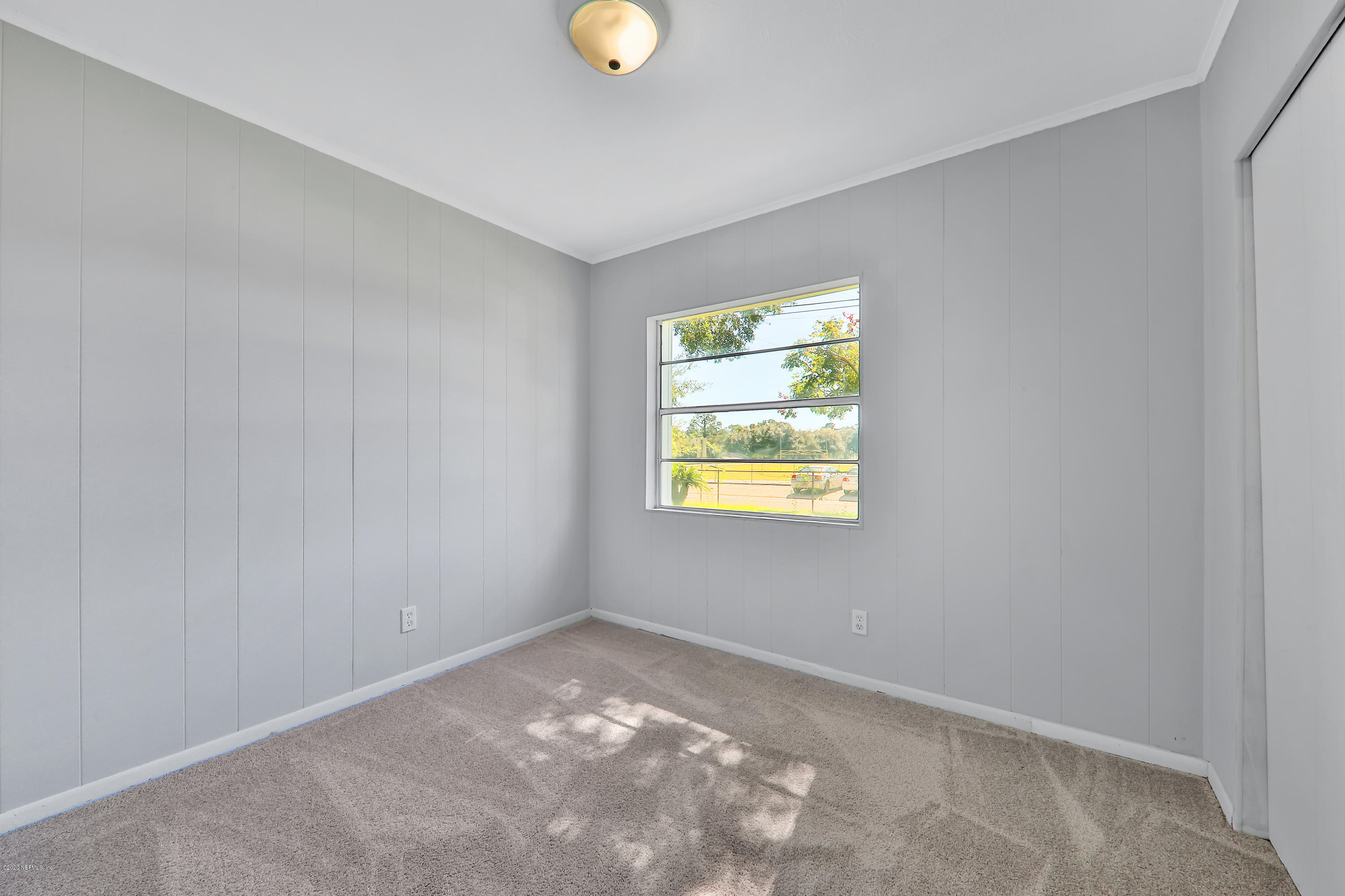 7019 Melvin Road Jacksonville, FL 32210 - Photo 16 of 22 an empty room with windows