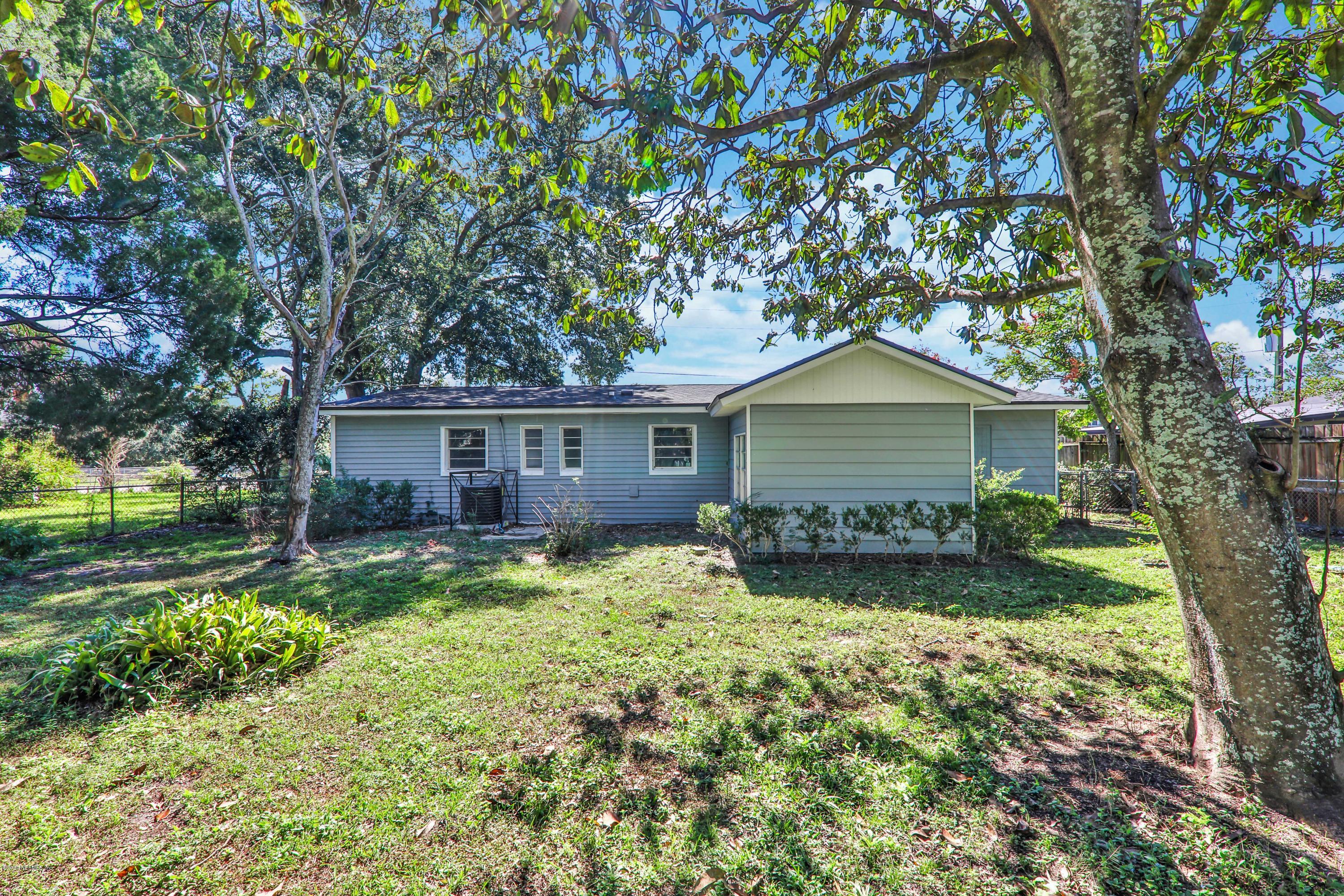 7019 Melvin Road Jacksonville, FL 32210 - Photo 20 of 22 a house that has tree in front of it