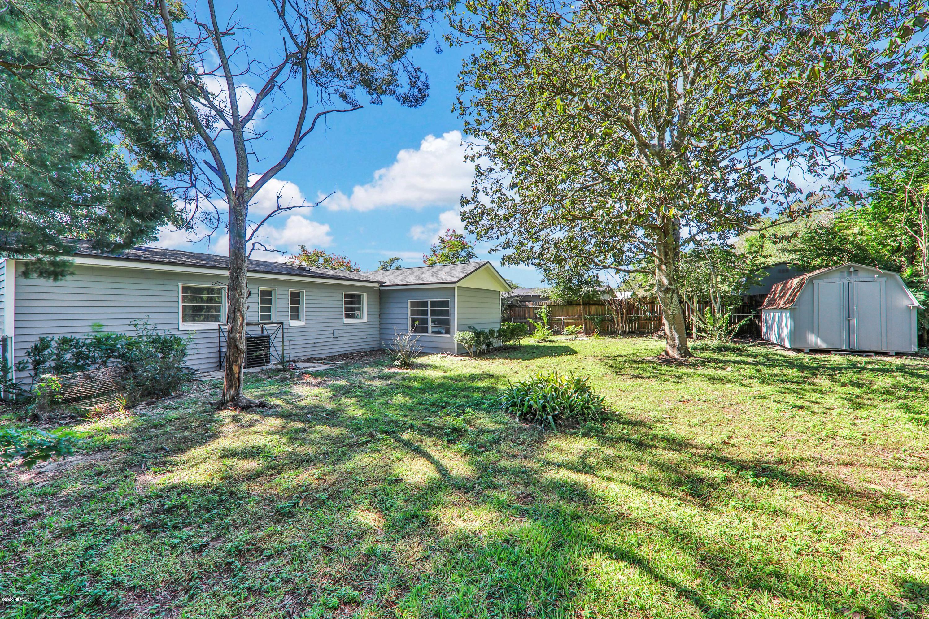 7019 Melvin Road Jacksonville, FL 32210 - Photo 21 of 22 a view of house with backyard space and garden