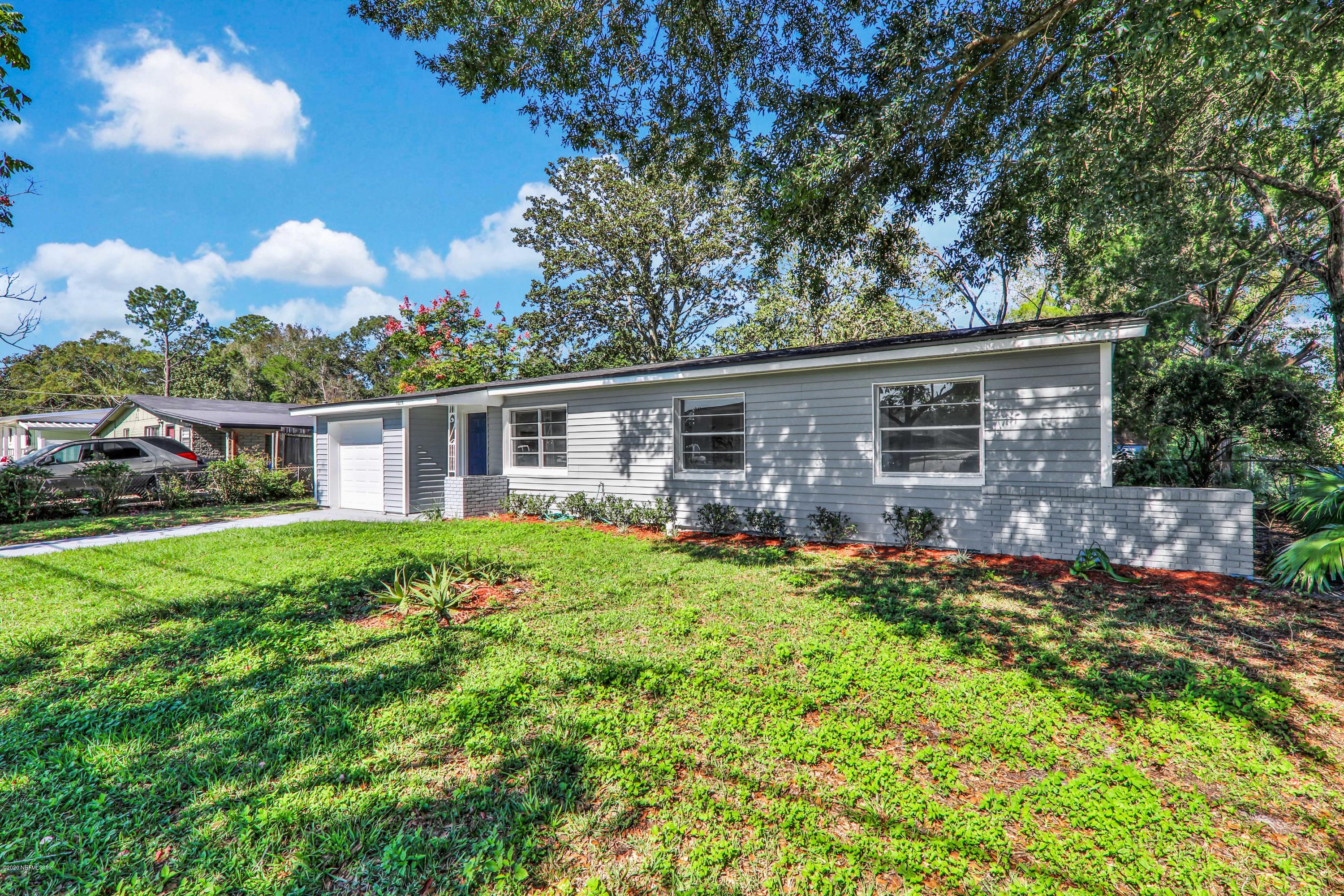 7019 Melvin Road Jacksonville, FL 32210 - Photo 22 of 22 front view of a house with a big yard