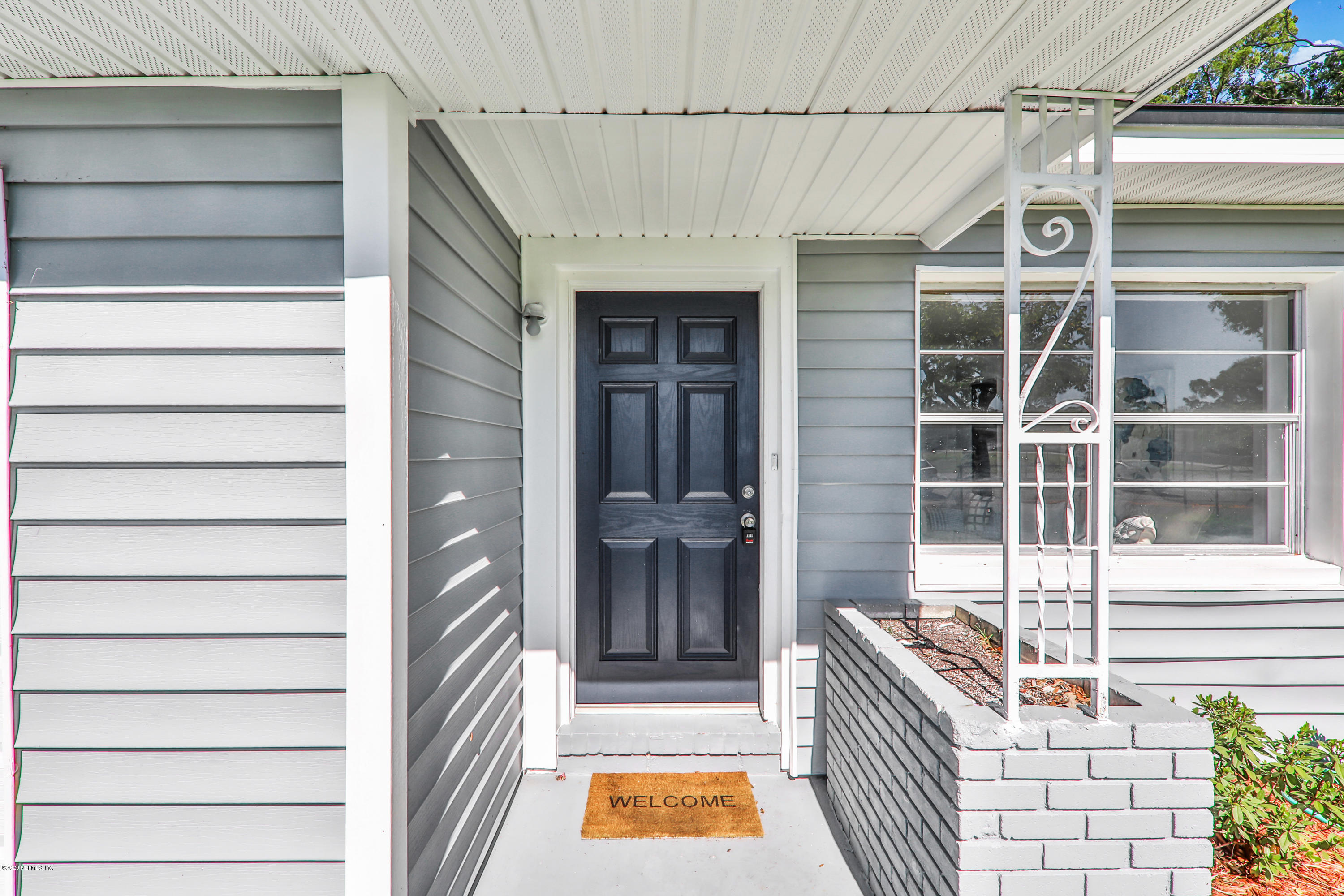 7019 Melvin Road Jacksonville, FL 32210 - Photo 3 of 22 a front view of a house with a door and a window