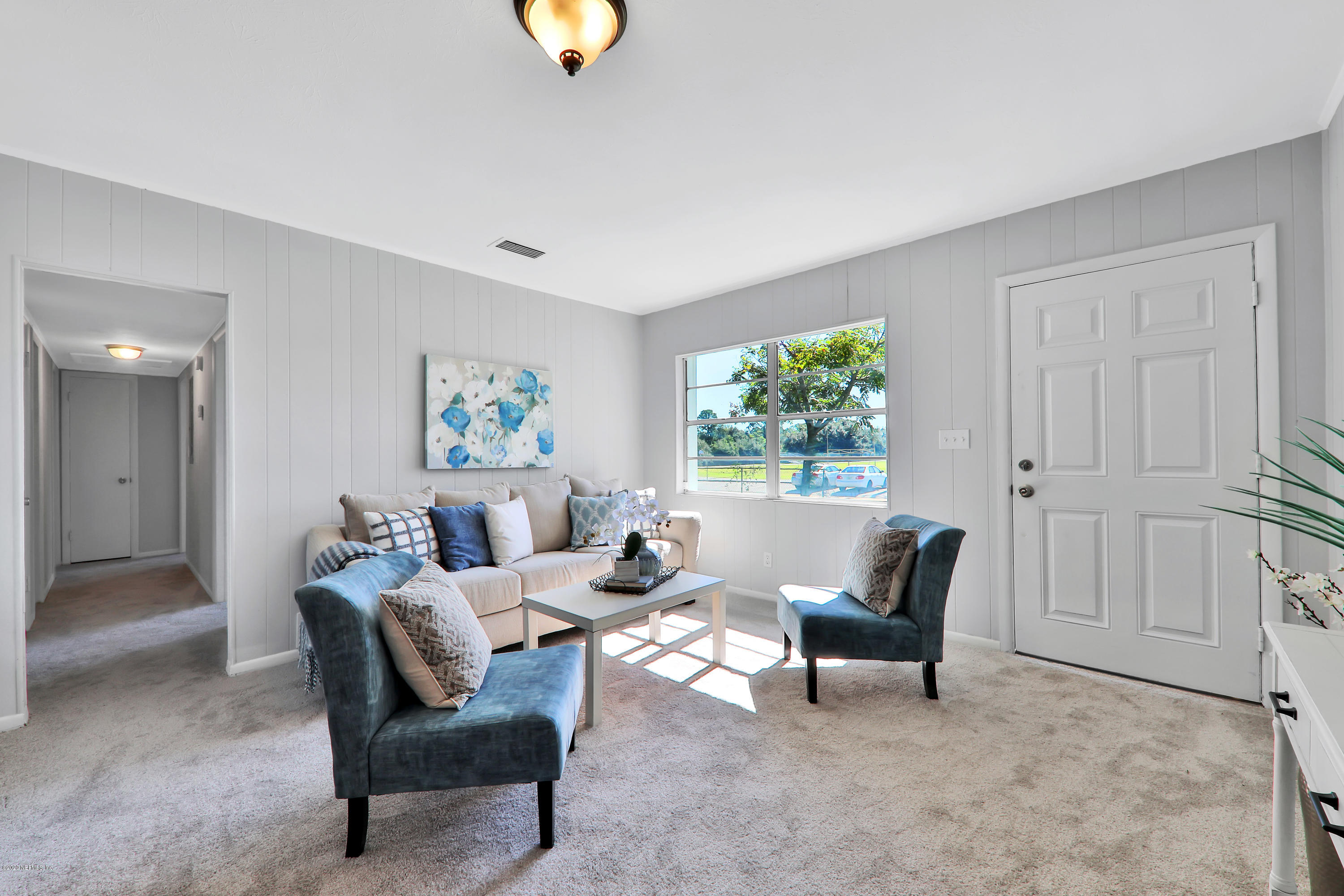 7019 Melvin Road Jacksonville, FL 32210 - Photo 4 of 22 a living room with furniture and a window