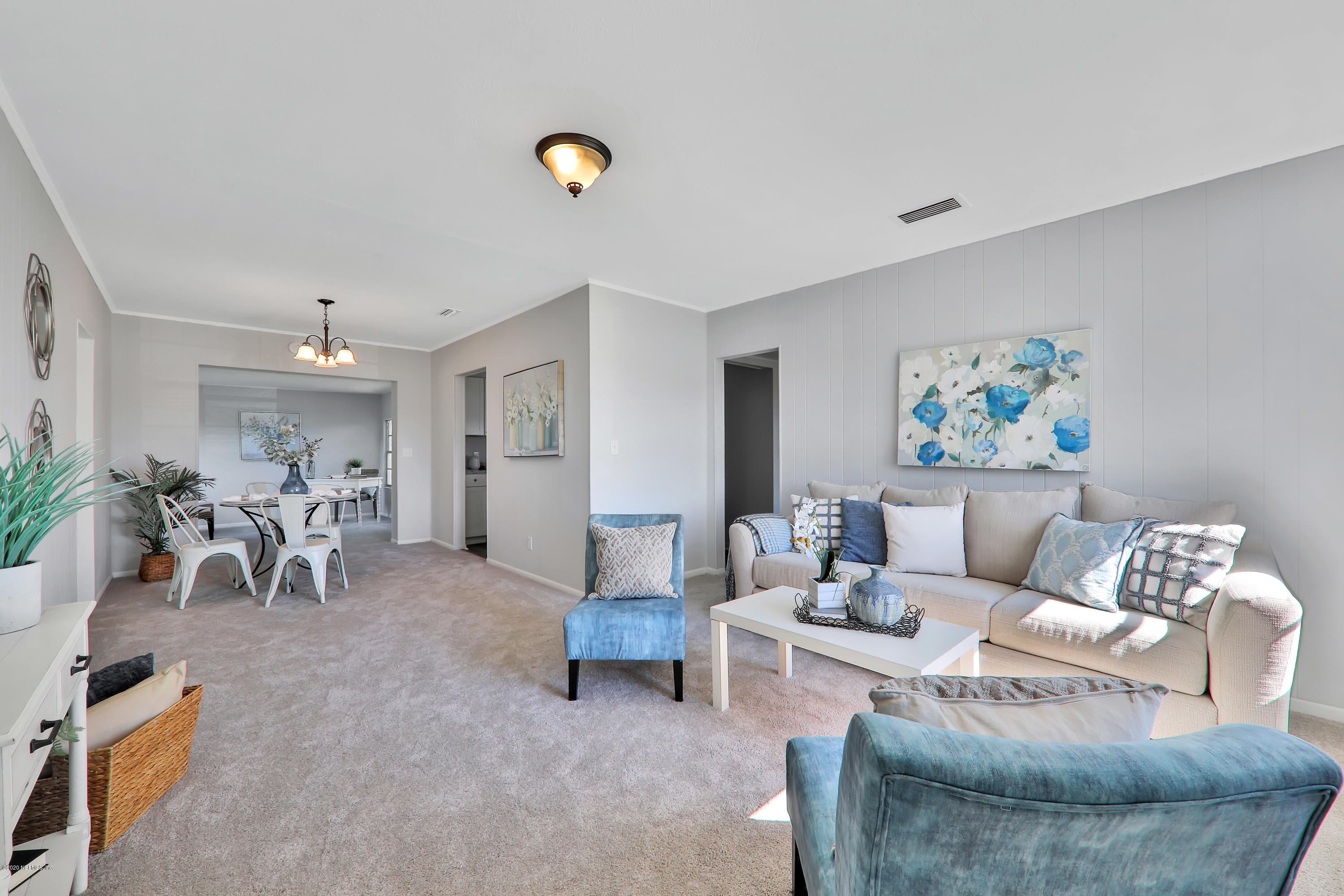 7019 Melvin Road Jacksonville, FL 32210 - Photo 5 of 22 a living room with furniture and a table