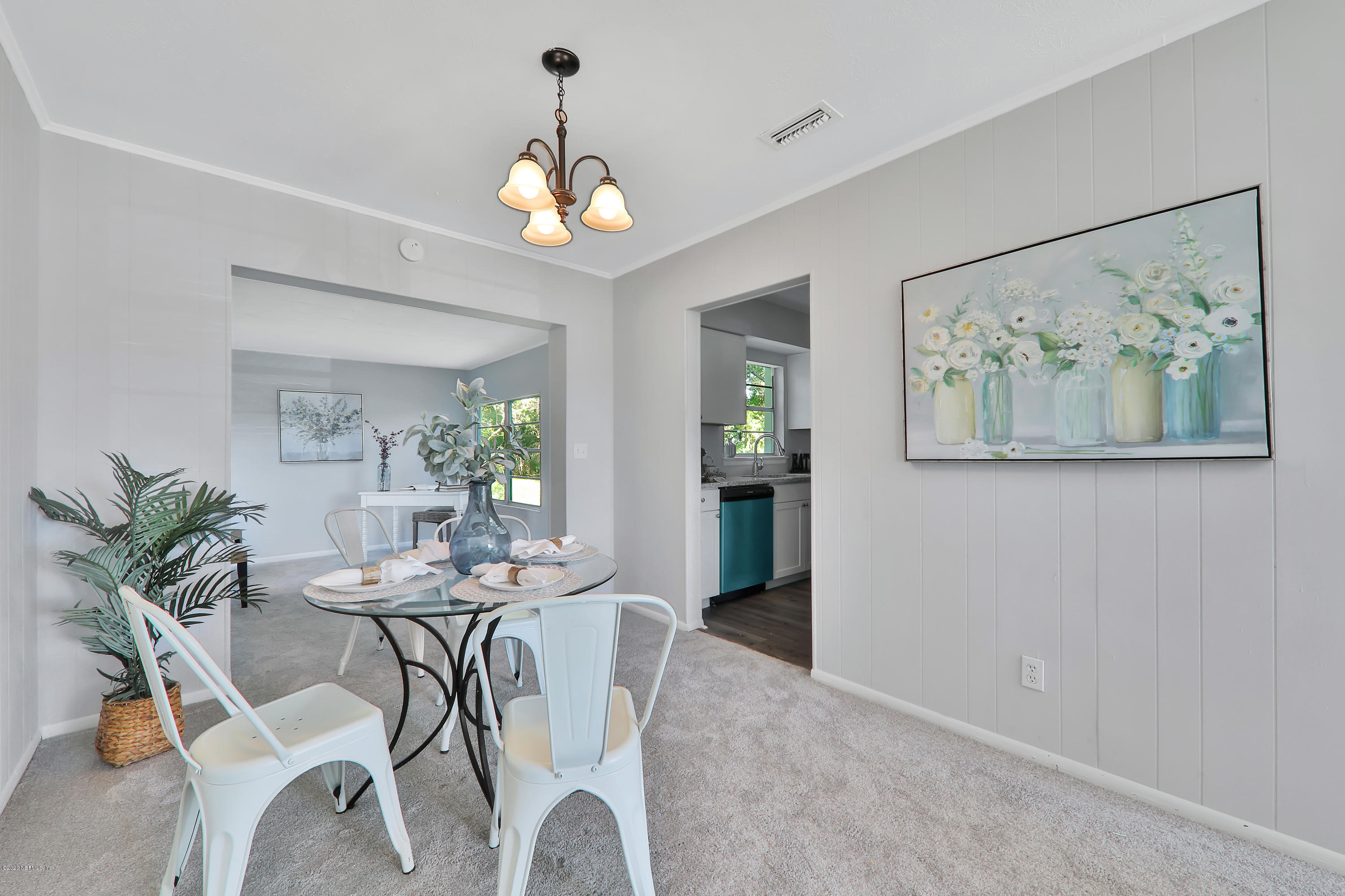 7019 Melvin Road Jacksonville, FL 32210 - Photo 6 of 22 a view of a dining room with furniture a chandelier and wooden floor