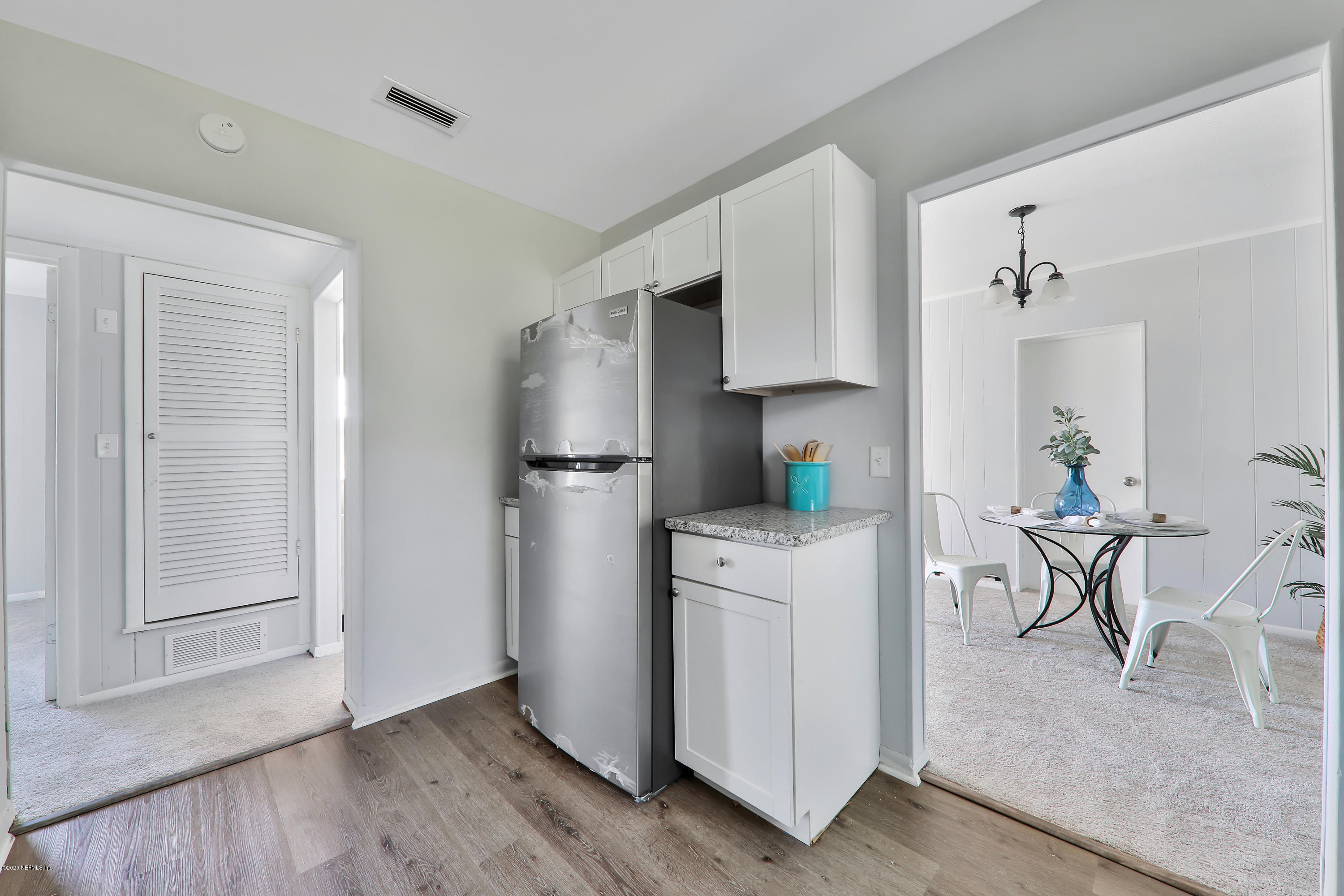 7019 Melvin Road Jacksonville, FL 32210 - Photo 8 of 22 a kitchen with stainless steel appliances a refrigerator and a stove top oven