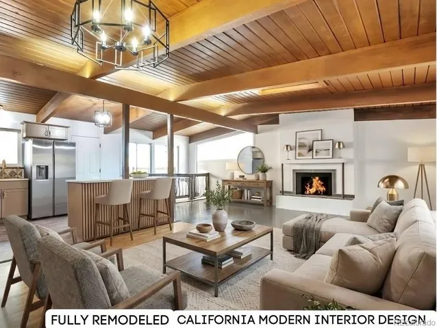a living room with furniture a fireplace and a chandelier