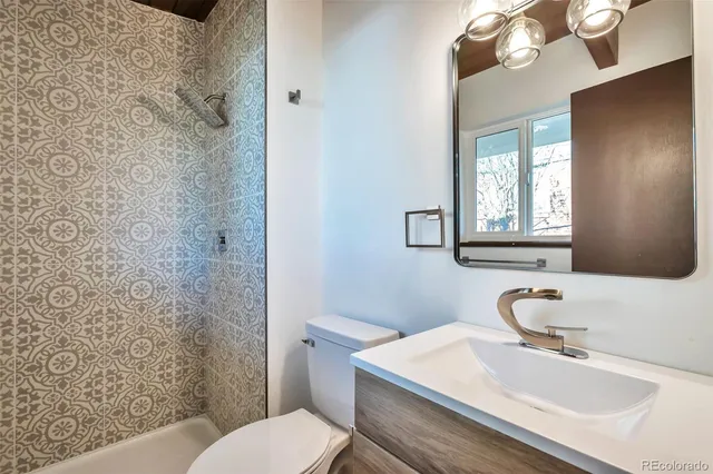 a bathroom with a sink toilet and shower