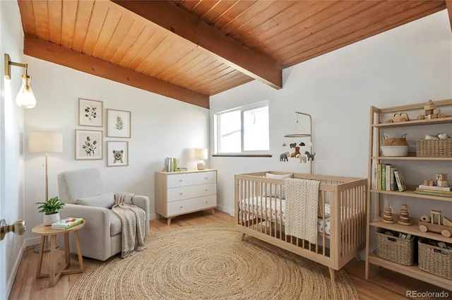 a bedroom with furniture and baby crib