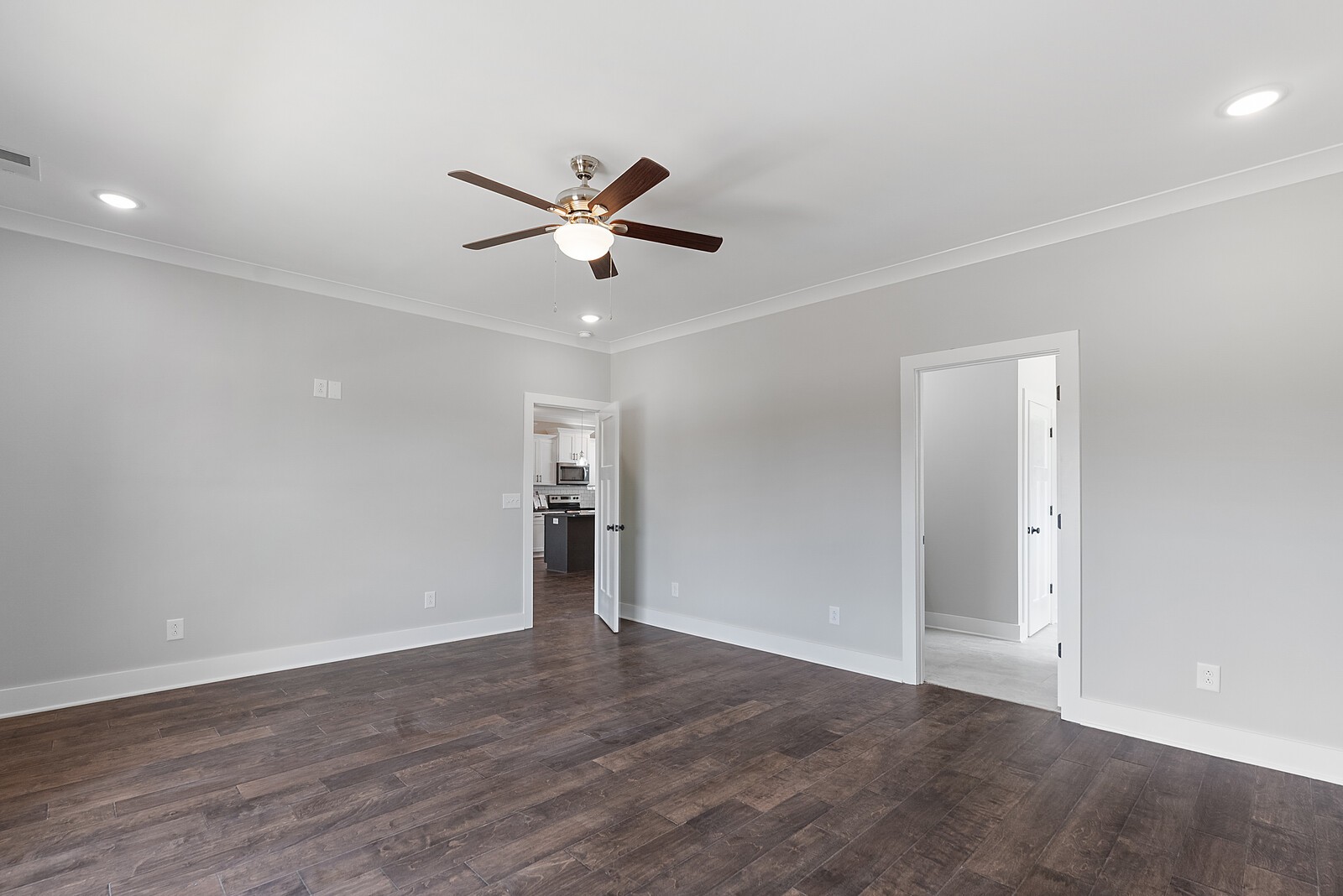 4462 Corbin Sneed Road Springfield, TN 37172 - Photo 11 of 22 an empty room with wooden floor and a ceiling fan