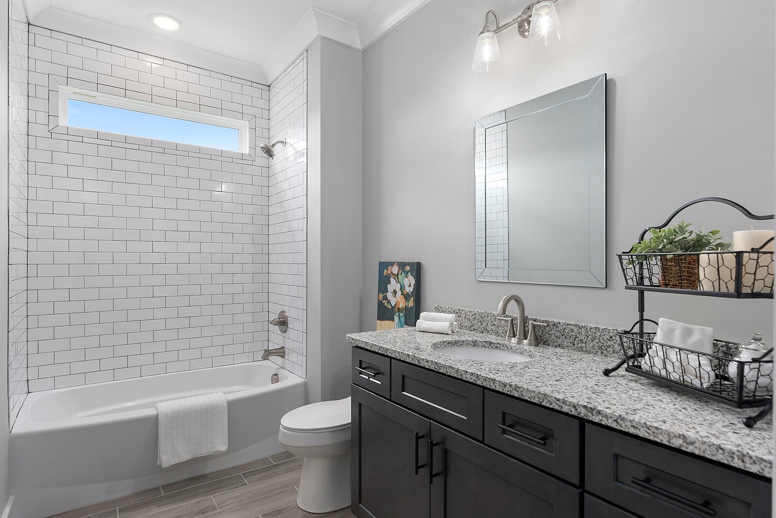 4462 Corbin Sneed Road Springfield, TN 37172 - Photo 16 of 22 a bathroom with a granite countertop sink a toilet a mirror a bathtub and shower