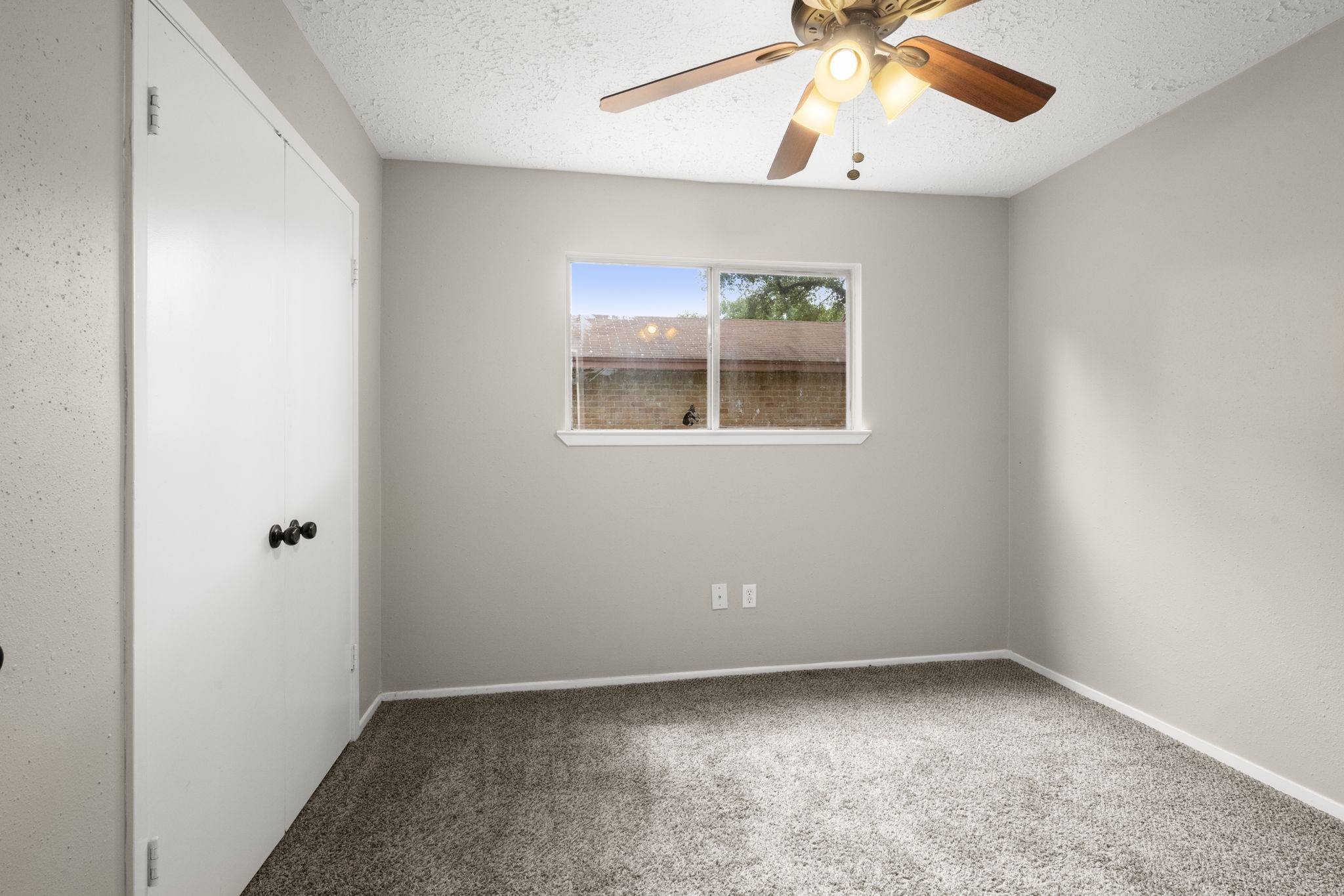 14219 Jaquine Drive Cypress, TX 77429 - Photo 12 of 16 an empty room with a window and a ceiling fan