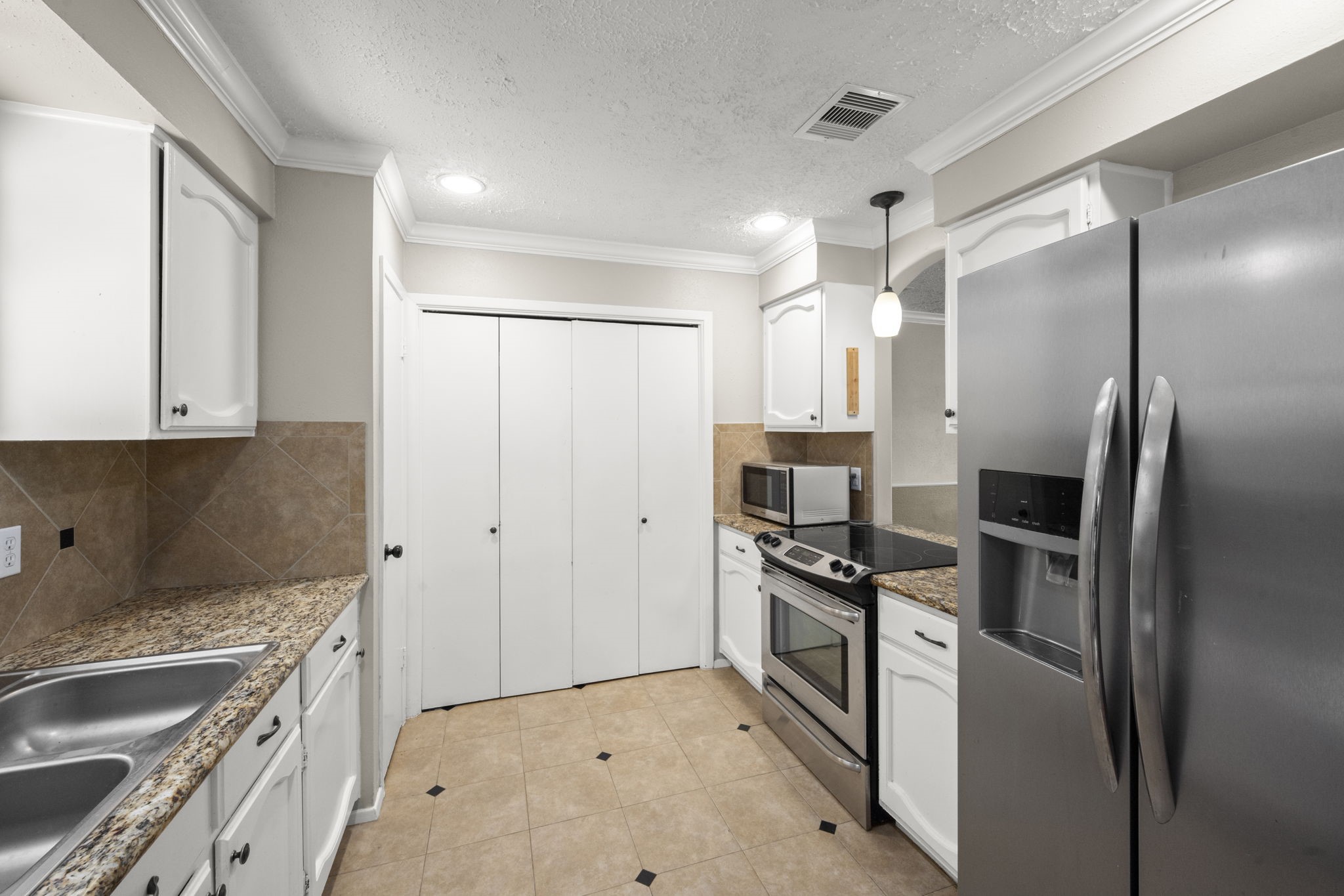 14219 Jaquine Drive Cypress, TX 77429 - Photo 5 of 16 a kitchen with a refrigerator and a sink