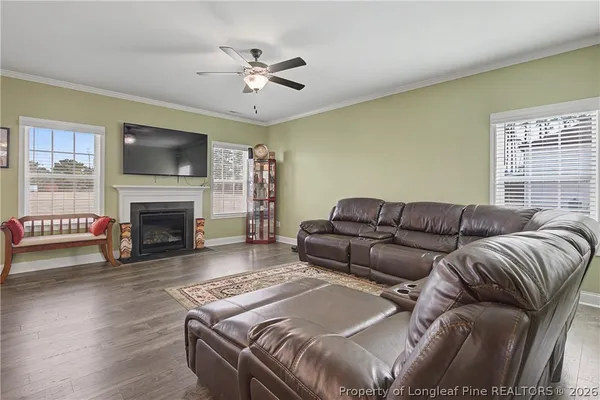 a living room with furniture and kitchen view