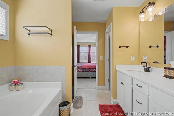 a spacious bathroom with a double vanity sink toilet and shower