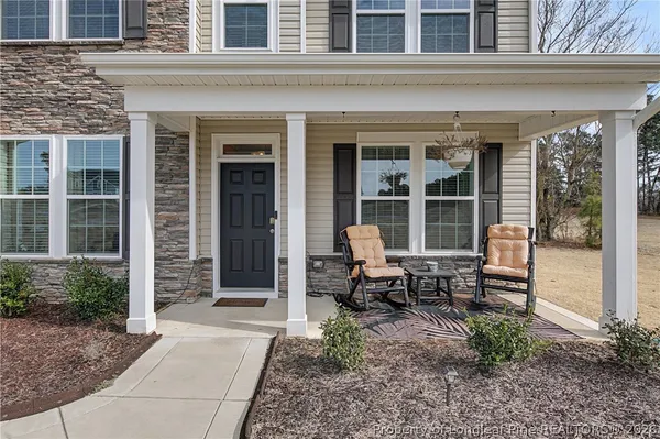 a backyard of a house with outdoor seating