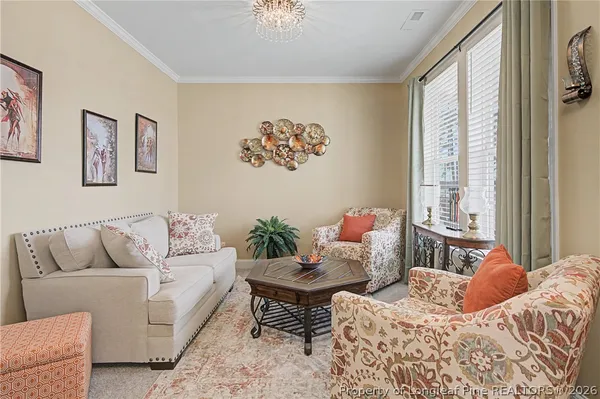 a living room with a couch a fireplace and a flat screen tv