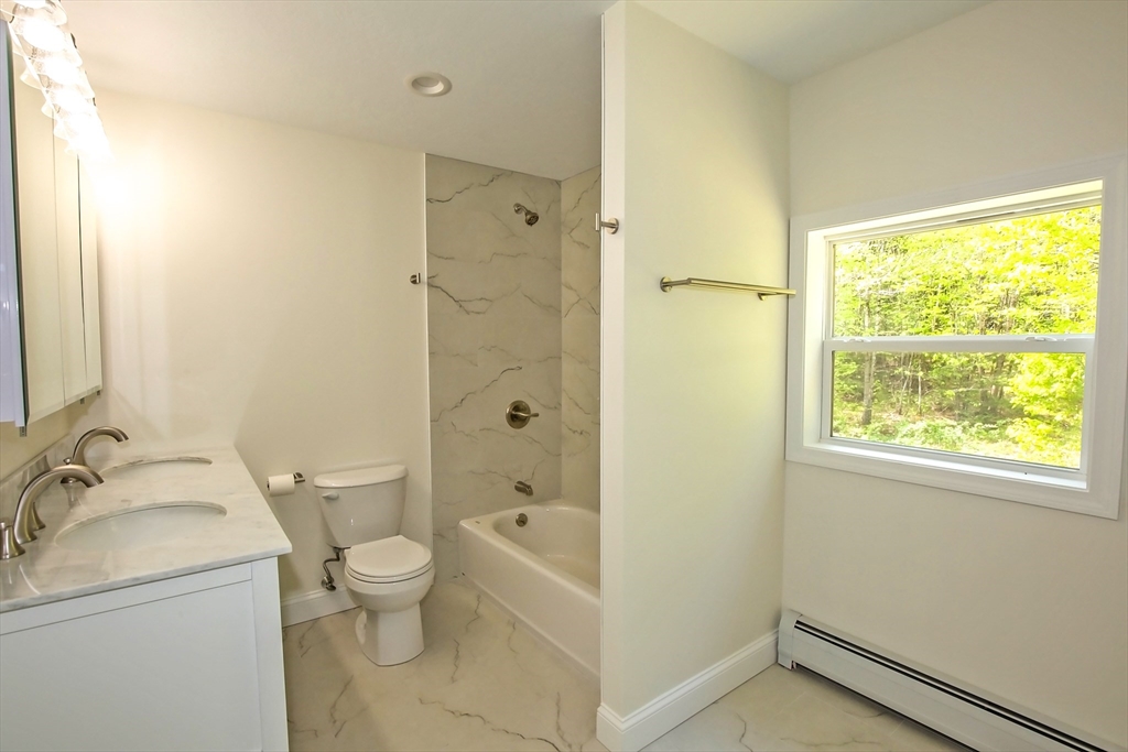 165 Sandisfield Road Sandisfield, MA 01255 - Photo 26 of 37 a bathroom with a granite countertop sink toilet and shower