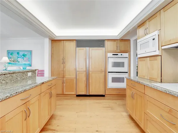 a kitchen with stainless steel appliances a refrigerator and cabinets