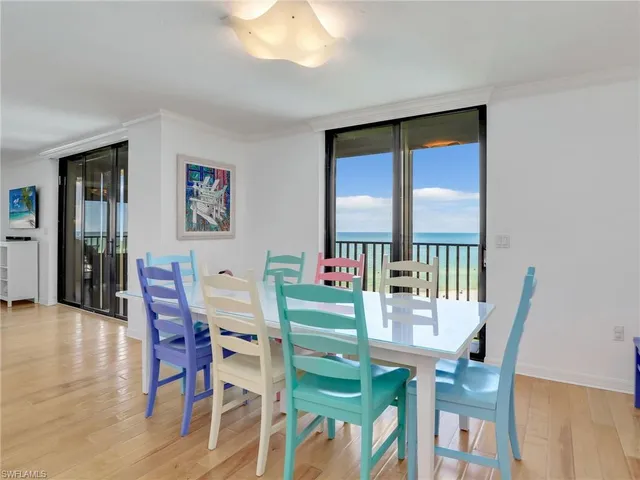 a view of a dining room with furniture and a potted plant