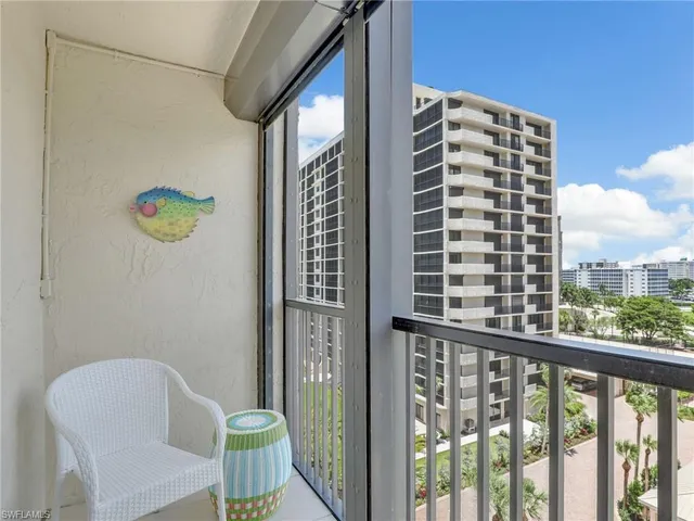 a view of balcony with two chairs and a window