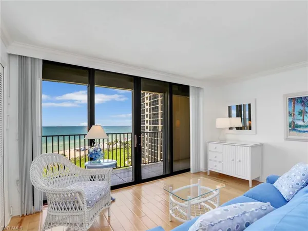 a bedroom with furniture and a large window