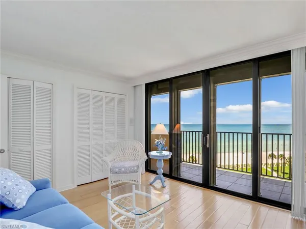 a living room with furniture and a floor to ceiling window