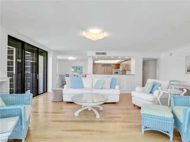a living room with furniture and large window