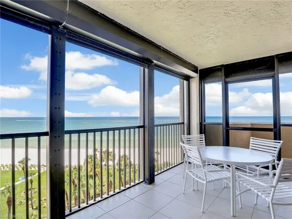 a view of a chairs and table in the balcony