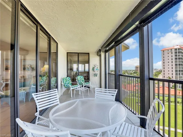 a dining room with furniture water view and a potted plant