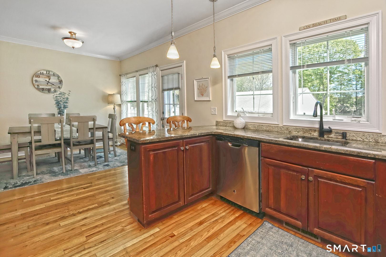 102 Lantern Court, Unit 102 Clinton, CT 06413 - Photo 15 of 36 a kitchen with granite countertop a stove a sink and dishwasher wooden cabinets with wooden floor