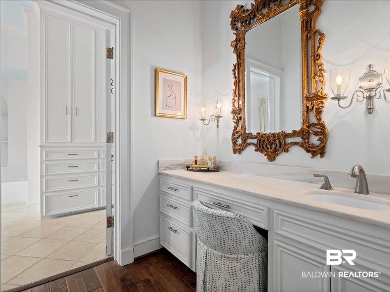 109 Eaton Square Mobile, AL 36608 - Photo 14 of 26 Vanity featuring a built-in sink, stone countertop, and ornate mirror