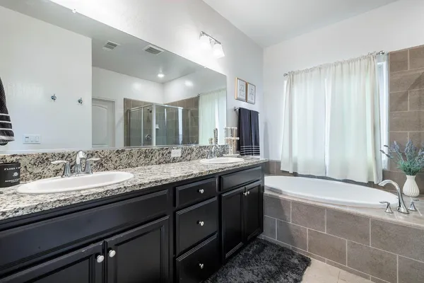 a bathroom with a shower a sink and mirror