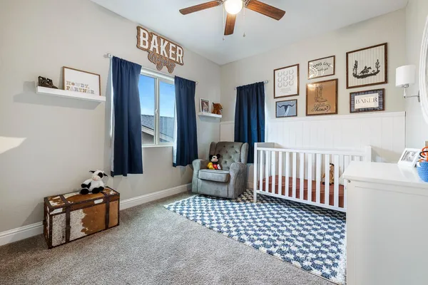 a bathroom with a granite countertop toilet sink and mirror