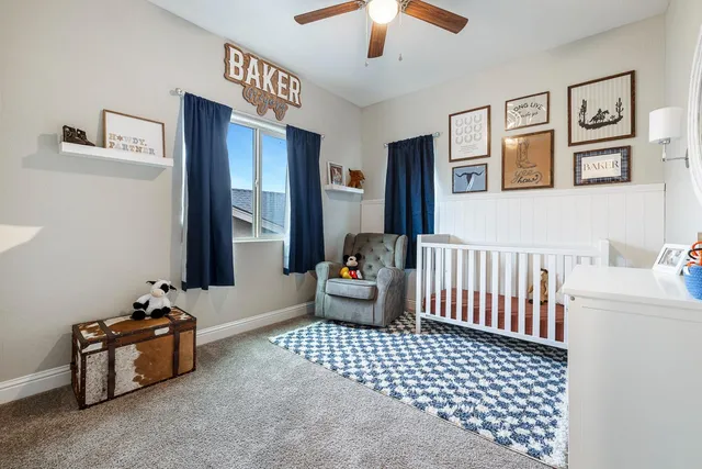 a bathroom with a granite countertop toilet sink and mirror