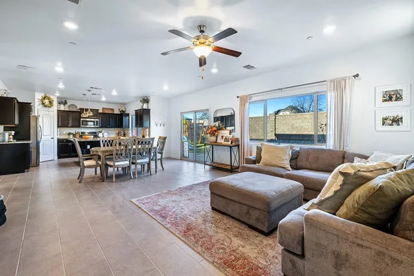 a dining room with furniture a rug and a flat screen tv