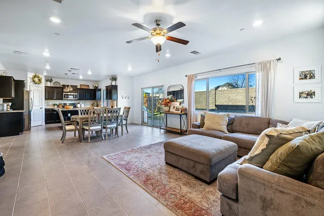 a dining room with furniture a rug and a flat screen tv