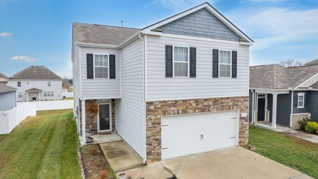 a front view of a house with a garden