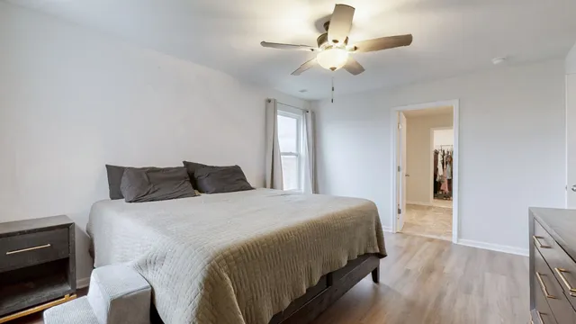 a bedroom with a large bed and a chandelier